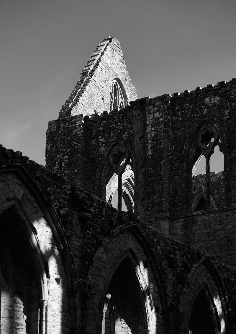 Walls of the ruin crossing across the image leading to a roof apex