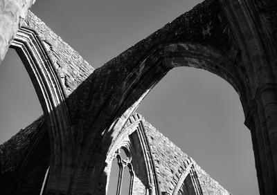 Shadow of arches being cast onto the walls of the ruin